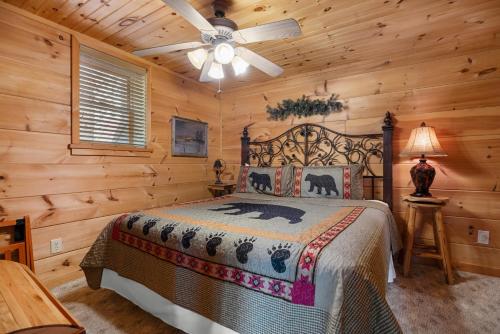 a bedroom with a bed and a ceiling fan at Beneath The Stars by American Patriot Getaways in Hatchertown
