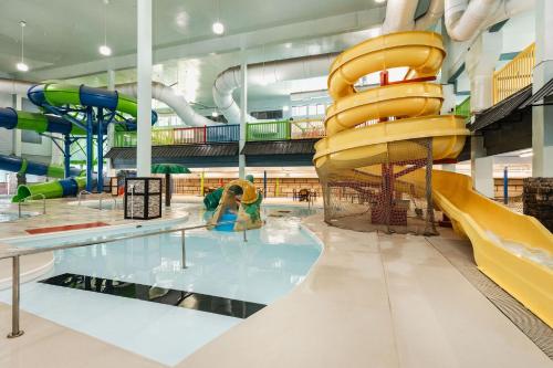 a large indoor water park with a slide at The Branson Waterpark Hotel in Branson