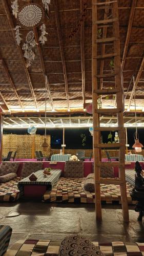 a large room with beds and a ladder in it at Hampi WildStone in Hampi
