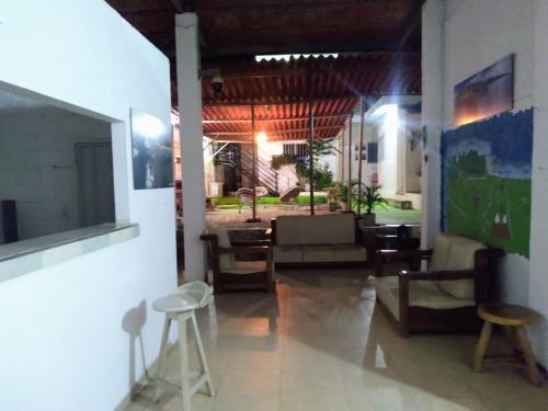 a living room with tables and chairs in a room at Taganga blue in Taganga