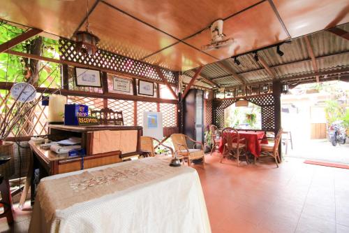 a room with a table and a dining room at Hotel O Ombak Inn Chalet in Pangkor