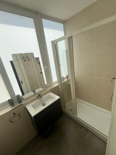 a bathroom with a sink and a shower at 5 Star Residence - Stylish Modern apartments in St Julians in St Julian's