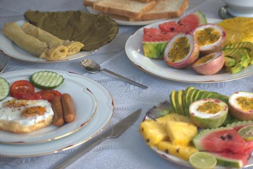 a table with plates of different types of food at New View Hikkaduwa in Hikkaduwa