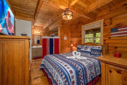 a bedroom with a bed in a wooden cabin at Old Glory by American Patriot Getaways in Catlettsburg