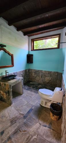 a bathroom with a toilet and a sink at La casa del sueño in Mazunte