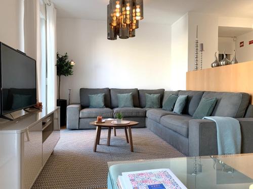 a living room with a couch and a table at MM1 Cosy & Central Apartment in Baixa with Castle View and Free Parking! in Lisbon