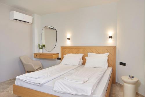 a bedroom with a bed with a mirror and a chair at Семеен хотел НОА in Nesebar