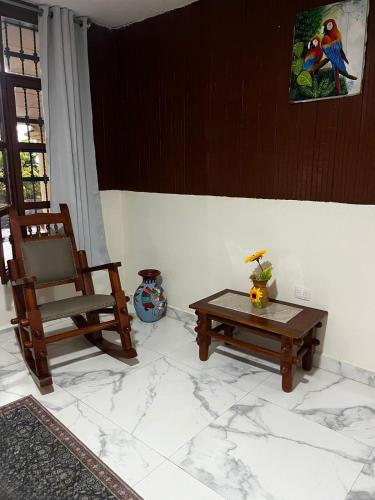 a living room with a chair and a table at Newly Remodeled Villa Las Flores, 11 guests 