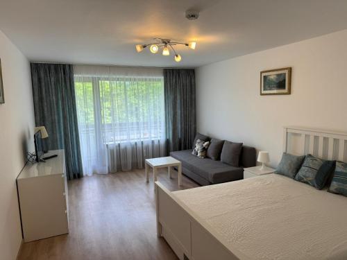 a bedroom with a bed and a couch in a room at Ferienwohnung Sofi in Bad Reichenhall