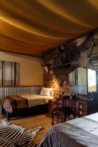 a bedroom with two beds in a room with a mural at Grootdraai Guest Farm in Adelaide