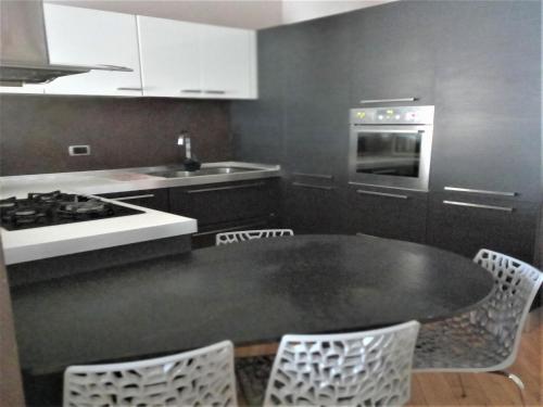 a kitchen with a table and chairs and a stove at Marone Apartment with Pool in Marone