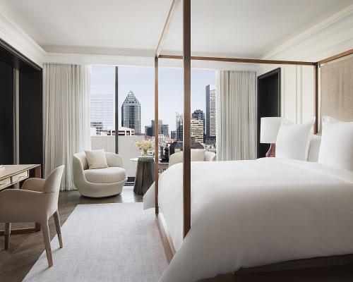 a hotel room with a large bed and a large window at Four Seasons Hotel Montreal in Montréal