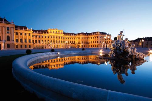 a building with a reflecting pool in front of it at Holiday Inn Vienna City by IHG in Vienna