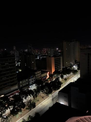 a view of a city at night with buildings at Flat Aconchegante in Goiânia