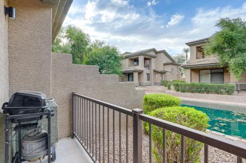 a fence next to a house with a swimming pool at 1 Mi to Golf Lake-View Condo with Pool in Chandler! in Chandler