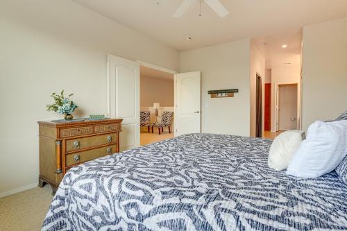 a bedroom with a bed with a blue and white comforter at 1 Mi to Golf Lake-View Condo with Pool in Chandler! in Chandler
