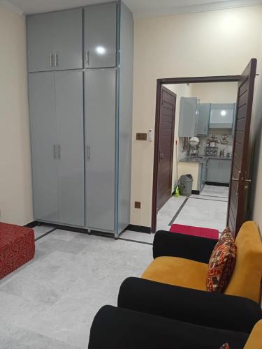 a living room with a mirror and a couch at Prime Executive Residence in Rawalpindi