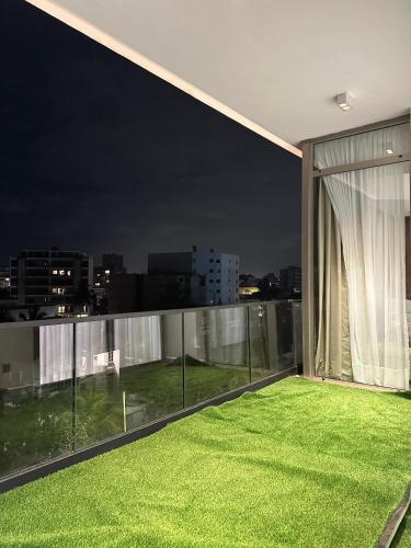 a balcony with a green lawn at night at Platinium résidence in Ngor