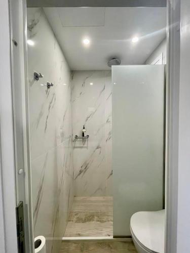 a bathroom with a shower with a toilet in it at Alexandra Suites & Rooms - MYKONOS PORT in Mýkonos City