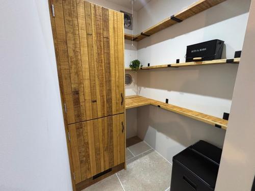 a room with a closet with a wooden door at Lime Tree House - Sleeps 12 - Hot Tub in Sudbury