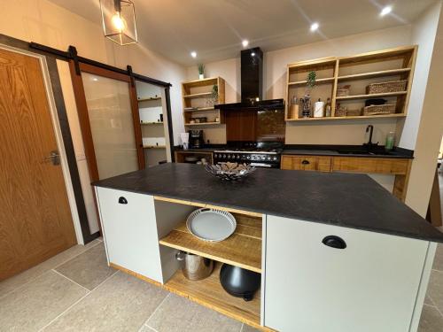 a kitchen with a black counter top in a room at Lime Tree House - Sleeps 12 - Hot Tub in Sudbury