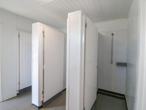 an empty room with white doors in a building at Bluebell Lodge in Battle