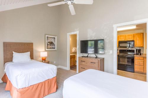 a hotel room with two beds and a tv at Massanuttens Shenandoah Villas by TripForth in McGaheysville