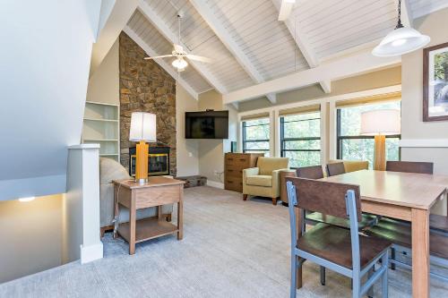 a dining room and living room with a table and chairs at Massanuttens Shenandoah Villas by TripForth in McGaheysville