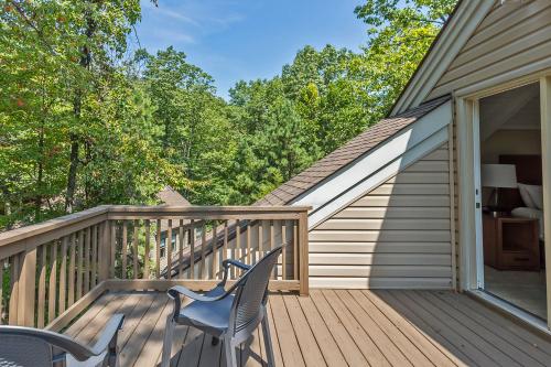 a wooden deck with two chairs on it at Massanuttens Shenandoah Villas by TripForth in McGaheysville