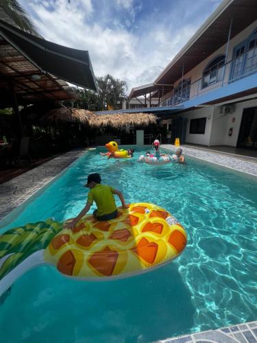 a group of people playing in a swimming pool at Hotel IBIZA Beach Boutique in Jacó