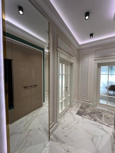a large room with a glass door and a window at Tashkent City Gardens Residence D11-4-27 in Tashkent