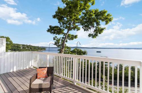 a bench on a deck with a view of the water at Entire Cozy Apartment with Share Jacuzzi to Enjoy Amazing Views in Halifax
