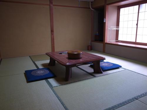a room with a table with a bowl on it at Ryokan Murayama in Takayama