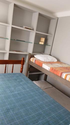 a bedroom with two bunk beds and a bed at Hostel Triplo J e Guest House in Salvador