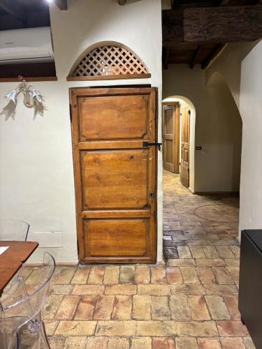 a wooden door in a room with a table at Domus Antica Navona in Rome