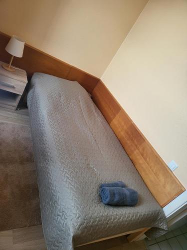 a bed in a room with a wooden headboard at Transhostel IRIS in Narva