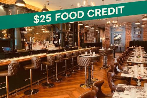 a restaurant with a bar with tables and chairs at The Beau Hotel Downtown San Diego Gaslamp Quarter in San Diego