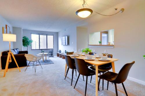 a dining room and living room with a table and chairs at Prime Location Near Pentagon and Metro in Arlington