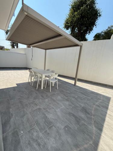a table and chairs under a canopy on a patio at Omai suite in Ortona