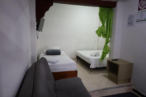 Una cama o camas en una habitación de Apartahotel El Horizonte