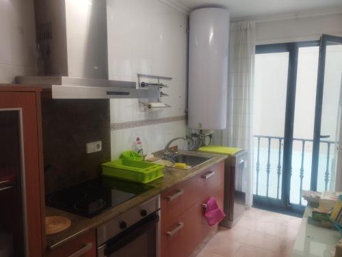 a kitchen with a sink and a counter top at Piso Ría de Ribadeo in Ribadeo