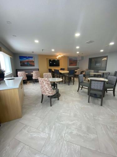 a waiting room with tables and chairs in a hospital at Best Western Montrose Inn in Montrose
