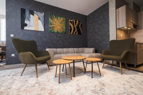 a living room with two chairs and a couch and two tables at А17 Plovdiv Apartments - Close to University hospitals, Rowing Channel and Mall Plovdiv in Plovdiv