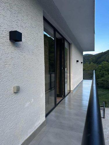 a building with glass doors on the side of it at Berg Ananuri in Ananuri