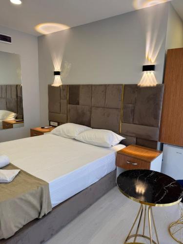 a bedroom with a large bed and a table at Mall Off Palace in Istanbul