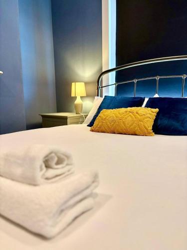 a bedroom with a bed with towels on it at Central 2br I Pets I Parking in Hereford