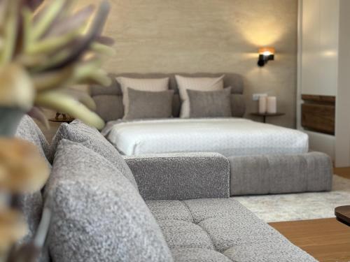 a living room with a bed and a couch at Vila Palas in Vrnjačka Banja