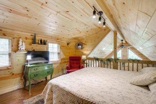 a bedroom with a bed and a television in a cabin at Idyllic Cabin in the Heart of Hocking Hills in Rockbridge