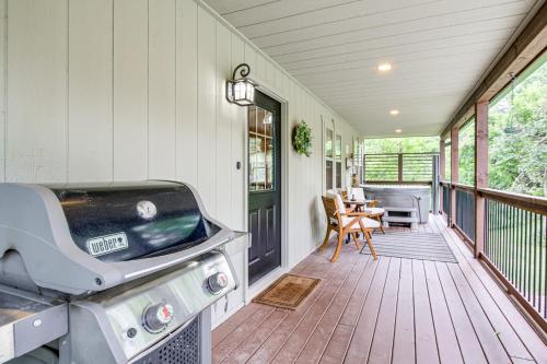 a screened in porch with a grill and a table at Idyllic Cabin in the Heart of Hocking Hills in Rockbridge