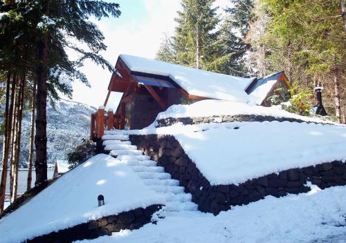 a snow covered building with snow covered steps at Costa Serena Aparts & Spa in Villa La Angostura